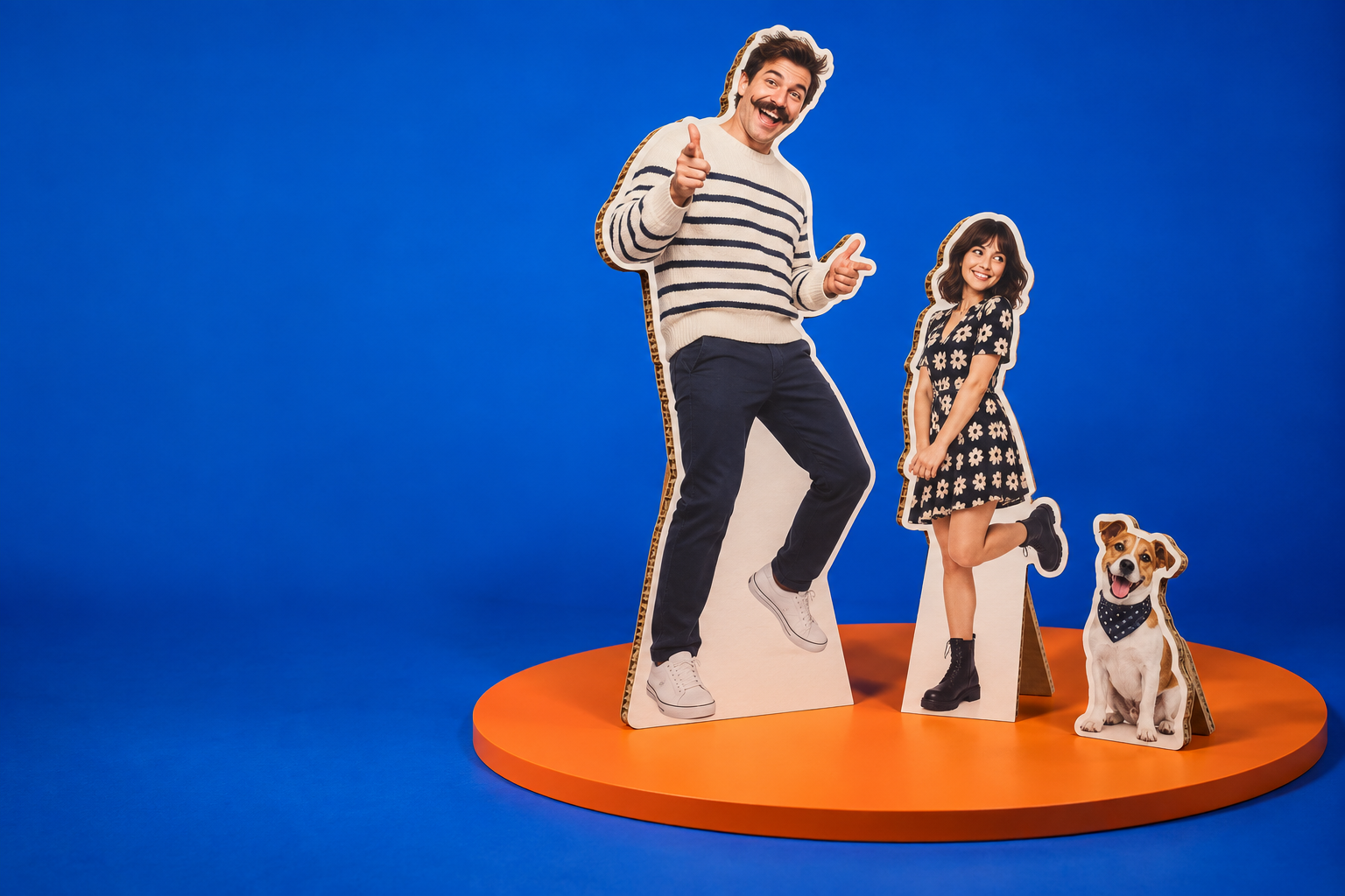 Three playful personalised cardboard cutouts on an orange platform